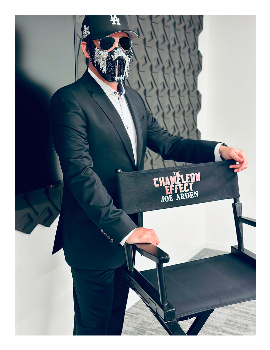 Picture of Joe in a suit with The Chameleon Effect director's chair